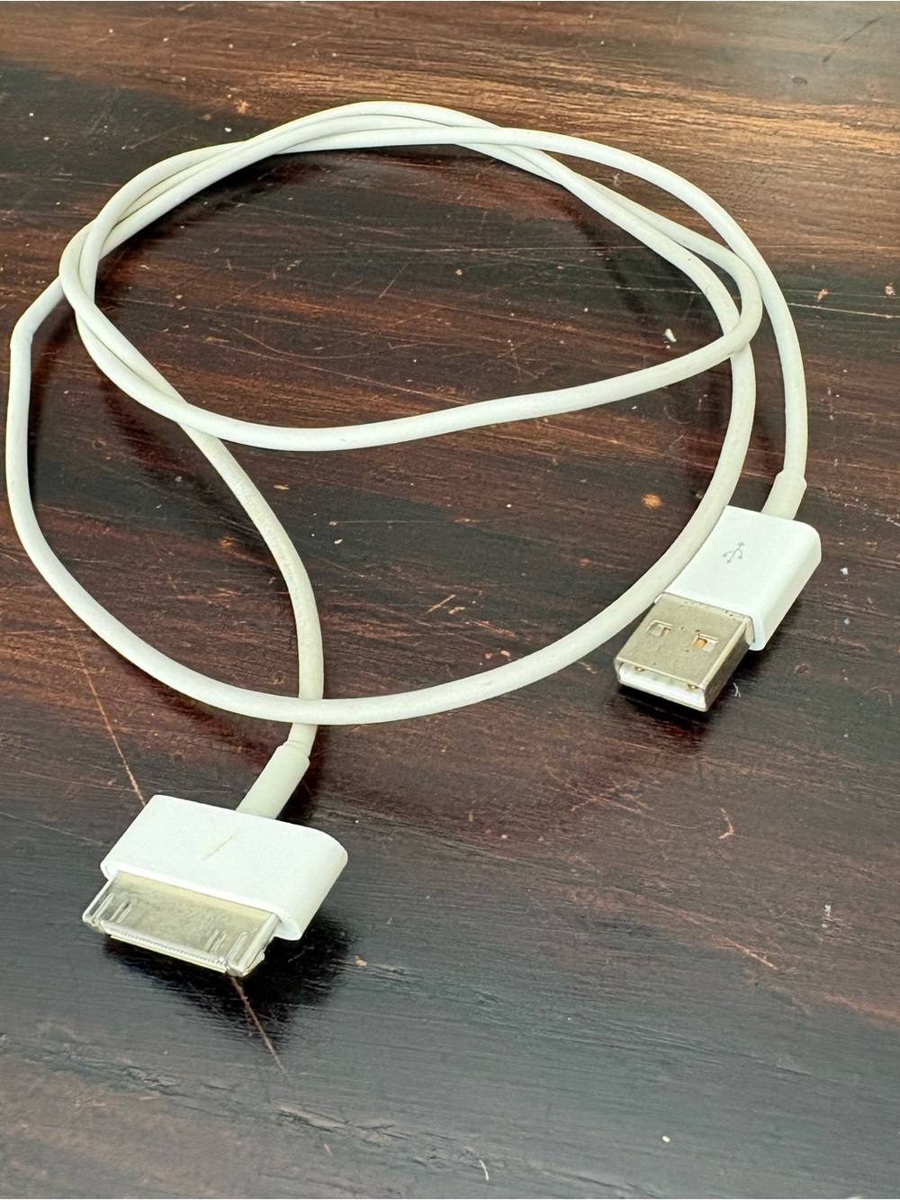 Apple 30-pin to USB-A charging and data sync cable.